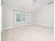 Neutral bedroom featuring vaulted ceilings and a large window at 3129 Elm Tree Ln, Raleigh, NC 27614