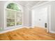 Bedroom with a large arched window, hardwood floors, and a walk-in closet at 3129 Elm Tree Ln, Raleigh, NC 27614