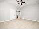 Spacious bedroom with neutral carpet, ceiling fan, and doorway to the bathroom at 3129 Elm Tree Ln, Raleigh, NC 27614