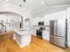 Open kitchen layout with granite island, stainless appliances, and white cabinetry at 3129 Elm Tree Ln, Raleigh, NC 27614