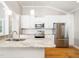 Bright kitchen with white cabinets, granite countertops, stainless appliances, and hardwood floors at 3129 Elm Tree Ln, Raleigh, NC 27614