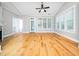 Spacious living room with hardwood floors, lots of windows, a door to the backyard, and neutral walls at 3129 Elm Tree Ln, Raleigh, NC 27614