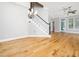 Open-concept living room with hardwood floors, staircase, and natural light at 3129 Elm Tree Ln, Raleigh, NC 27614