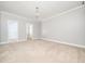 Spacious main bedroom with neutral carpet, crown molding and two open doorways at 3129 Elm Tree Ln, Raleigh, NC 27614