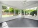 Bright sunroom with floor-to-ceiling windows and a ceiling fan overlooks the green yard at 3129 Elm Tree Ln, Raleigh, NC 27614