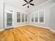 Light-filled sunroom featuring hardwood floors, a ceiling fan, and multiple windows at 3129 Elm Tree Ln, Raleigh, NC 27614