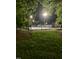 Night view of the tennis court showcasing recreational amenities at 3129 Elm Tree Ln, Raleigh, NC 27614
