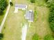 This aerial view displays two homes surrounded by mature trees and large grassy areas at 3354 Altamahaw Church Rd, Elon, NC 27244
