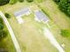 An aerial view shows two homes surrounded by large grassy yards and a long driveway at 3354 Altamahaw Church Rd, Elon, NC 27244