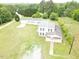 An aerial view of a house with a long driveway and surrounded by trees at 3354 Altamahaw Church Rd, Elon, NC 27244