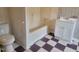 Bathroom featuring a shower-tub combo and a white vanity with checkerboard tile floors at 3354 Altamahaw Church Rd, Elon, NC 27244