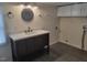 Bathroom features a modern vanity with a white countertop and a round mirror above the sink at 3354 Altamahaw Church Rd, Elon, NC 27244