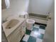 Standard bathroom with vanity sink, toilet, and green-trimmed tub, plus green and white checkered floors at 3354 Altamahaw Church Rd, Elon, NC 27244