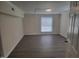 Simple bedroom featuring clean walls, a large window, and modern vinyl flooring at 3354 Altamahaw Church Rd, Elon, NC 27244