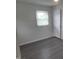 This bedroom has hard surface floors and a large window letting in natural light at 3354 Altamahaw Church Rd, Elon, NC 27244