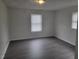 This bedroom has hard surface floors and two large windows letting in lots of natural light at 3354 Altamahaw Church Rd, Elon, NC 27244