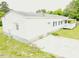 A white single story home features dark shutters, a small porch, and metal skirting at 3354 Altamahaw Church Rd, Elon, NC 27244