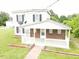 A two-story home with a brick and white porch, captured from an aerial view at 3354 Altamahaw Church Rd, Elon, NC 27244