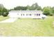 This is the exterior of a white single story home with a charming porch and a large grassy lawn at 3354 Altamahaw Church Rd, Elon, NC 27244