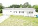 This exterior view shows a white single story home with black shutters and a charming front porch at 3354 Altamahaw Church Rd, Elon, NC 27244