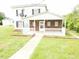 Two story house with brick porch and white railing at 3354 Altamahaw Church Rd, Elon, NC 27244