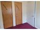 A hallway featuring several doors, each labeled with a unique name or designation at 3354 Altamahaw Church Rd, Elon, NC 27244