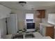 The kitchen features checkered floors, a white refrigerator, and a white oven at 3354 Altamahaw Church Rd, Elon, NC 27244