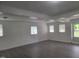 The living room has hard surface floors and lots of natural light from the large windows at 3354 Altamahaw Church Rd, Elon, NC 27244