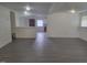 Spacious living area with gray vinyl floors that connects seamlessly with a modern kitchen space at 3354 Altamahaw Church Rd, Elon, NC 27244