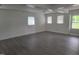 The living room has hard surface floors and lots of natural light from the three large windows at 3354 Altamahaw Church Rd, Elon, NC 27244