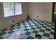 The room has checkered floors and a window letting in natural light at 3354 Altamahaw Church Rd, Elon, NC 27244
