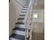 Clean, painted stairs lead to the upper level, with a glimpse of the open floor plan at 3354 Altamahaw Church Rd, Elon, NC 27244