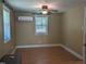 Neutral bedroom with a ceiling fan, window, and wood-look floors at 3405 Ode Turner Rd, Hillsborough, NC 27278