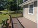 A cozy wooden deck with wood railing offers a view of the surrounding greenery and adds outdoor living space at 3405 Ode Turner Rd, Hillsborough, NC 27278