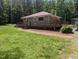 Charming single-story home featuring a spacious wraparound deck and a well-maintained lawn at 3405 Ode Turner Rd, Hillsborough, NC 27278