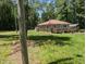 Traditional home with a spacious lawn and a covered parking area nestled among lush trees at 3405 Ode Turner Rd, Hillsborough, NC 27278