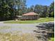 Single-level home showcases a long driveway, covered parking, and a large, private lot at 3405 Ode Turner Rd, Hillsborough, NC 27278