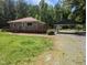 Traditional home boasts a covered parking area and lush green space surrounded by trees at 3405 Ode Turner Rd, Hillsborough, NC 27278
