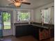 Well-lit kitchen features black cabinetry, generous countertop space, and view to the lush outdoors at 3405 Ode Turner Rd, Hillsborough, NC 27278