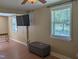 Bright living room features hardwood floors, large window, ceiling fan, and TV, creating an inviting space at 3405 Ode Turner Rd, Hillsborough, NC 27278