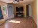 Open living room featuring wood-look floors, a ceiling fan, and a light blue door at 3405 Ode Turner Rd, Hillsborough, NC 27278