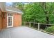 Spacious grey back deck overlooking lush green backyard, brick home and white trim at 3509 Carlton Square Pl, Raleigh, NC 27612