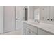 This bright bathroom boasts a white vanity, a large mirror, and a door to the toilet at 3509 Carlton Square Pl, Raleigh, NC 27612