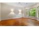 Spacious bedroom features hardwood floors, neutral walls, and a window overlooking the lush landscape at 3509 Carlton Square Pl, Raleigh, NC 27612