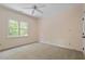 Bedroom with neutral carpet and walls with a ceiling fan and window at 3509 Carlton Square Pl, Raleigh, NC 27612