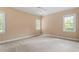 Bright bedroom featuring neutral walls, carpet floors, and natural light from surrounding windows at 3509 Carlton Square Pl, Raleigh, NC 27612