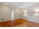 Bright bedroom with hardwood flooring, ceiling fan, neutral paint, and well lit sconces at 3509 Carlton Square Pl, Raleigh, NC 27612