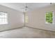 Bedroom with neutral carpet and walls and two windows providing natural light at 3509 Carlton Square Pl, Raleigh, NC 27612