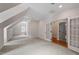Spacious bonus room with white trim, neutral walls, hardwood floors, and elegant french doors at 3509 Carlton Square Pl, Raleigh, NC 27612