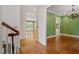 Hallway with hardwood floors, white trim, and open access to rooms with natural light at 3509 Carlton Square Pl, Raleigh, NC 27612